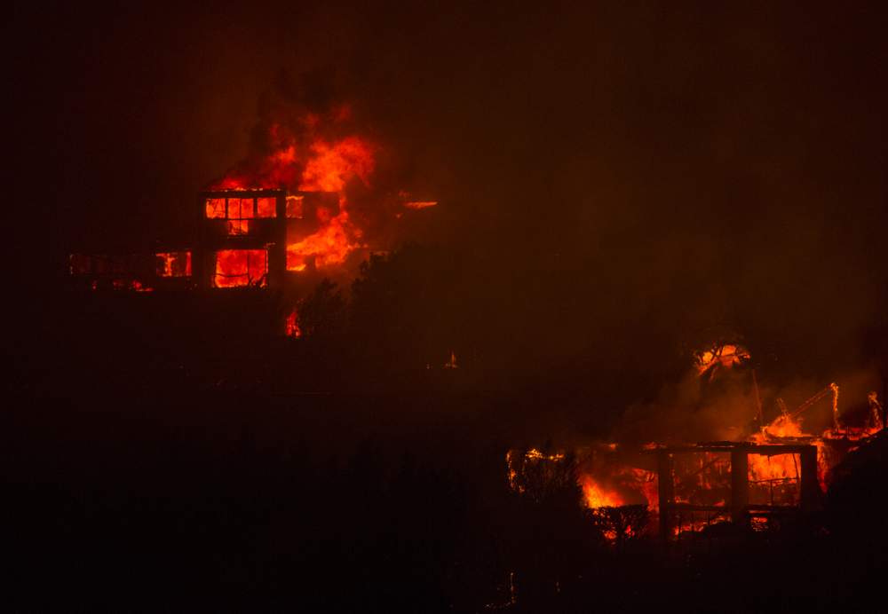 Houses on Worsleys Rd are engulfed in flames.  PHOTO: JOSEPH JOHNSON\/FAIRFAX NZ Houses on Worsleys Rd are engulfed in flames.  PHOTO: JOSEPH JOHNSON\/FAIRFAX NZ